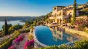A luxurious villa perched elegantly on a hill, featuring a sparkling swimming pool and a vibrant garden bursting with colorful flowers, all perfectly reflected in a serene body of water or a polished surface. The.webp